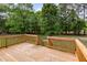 Wood deck overlooking backyard with lush green trees and a serene setting at 168 Hoss Ridge Ln, Dunn, NC 28334
