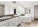 Bright bathroom with dual sinks, a soaking tub, and a neutral color scheme at 168 Hoss Ridge Ln, Dunn, NC 28334