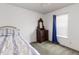 Bedroom with dresser, carpet flooring, and bright window at 168 Hoss Ridge Ln, Dunn, NC 28334