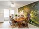 Bright dining room with a classic wood table set and a scenic mural accent wall at 168 Hoss Ridge Ln, Dunn, NC 28334