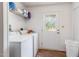 Functional laundry room with washer, dryer, storage shelves, and exterior access at 168 Hoss Ridge Ln, Dunn, NC 28334