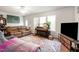 Cozy living room with comfortable seating, piano, and ample natural light at 168 Hoss Ridge Ln, Dunn, NC 28334
