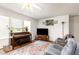 Spacious living room with plush seating, entertainment center, and large windows at 168 Hoss Ridge Ln, Dunn, NC 28334