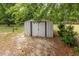 A metal shed under the shade of mature trees offers plenty of extra storage at 168 Hoss Ridge Ln, Dunn, NC 28334