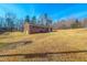 Rear exterior view of a brick home with an expansive yard at 178 Medford Oakley Rd, Rougemont, NC 27572