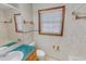 Bathroom featuring white tile, turquoise countertop, and window with natural light at 178 Medford Oakley Rd, Rougemont, NC 27572