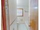 Bathroom featuring white tile, bathtub and shower, and a window with natural light at 178 Medford Oakley Rd, Rougemont, NC 27572