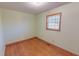 Bedroom featuring wood floors, window with blinds and light green painted walls at 178 Medford Oakley Rd, Rougemont, NC 27572