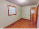Bedroom features wood floors, window with blinds and light green painted walls and wood trim at 178 Medford Oakley Rd, Rougemont, NC 27572