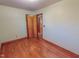 Bedroom featuring wood floors, window with blinds and light green painted walls and wood trim at 178 Medford Oakley Rd, Rougemont, NC 27572