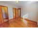 Bedroom featuring hardwood floors, neutral walls, and multiple doorways at 178 Medford Oakley Rd, Rougemont, NC 27572