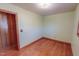 Bedroom featuring wood floors, window with blinds and light green painted walls and wood trim at 178 Medford Oakley Rd, Rougemont, NC 27572