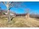 Charming brick home with covered porch, carport, and mature trees on a sunny day at 178 Medford Oakley Rd, Rougemont, NC 27572
