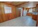 Cozy eat-in kitchen featuring wood paneling, tiled floor, and white appliances at 178 Medford Oakley Rd, Rougemont, NC 27572