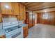 Eat-in kitchen featuring wood cabinets and white appliances at 178 Medford Oakley Rd, Rougemont, NC 27572