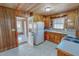 Kitchen featuring wooden cabinets, tile floors, and white appliances at 178 Medford Oakley Rd, Rougemont, NC 27572