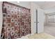 Bathroom showing tub/shower combo with decorative curtain, closet, and partial view of bedroom at 1839 Huntley Way, Burlington, NC 27215