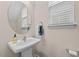 Bathroom featuring a pedestal sink, decorative mirror, and bright natural lighting at 1839 Huntley Way, Burlington, NC 27215