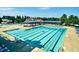 Spacious community pool offering a lap swimming area, splash features, and shaded seating for guests at 1839 Huntley Way, Burlington, NC 27215