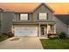 Charming two-story home with a well-manicured lawn and a two-car garage, perfect for families at 1839 Huntley Way, Burlington, NC 27215