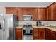 Modern kitchen featuring stainless steel appliances, granite countertops, and stylish wood cabinetry at 1839 Huntley Way, Burlington, NC 27215