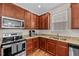 Modern kitchen featuring stainless steel appliances, granite countertops, and stylish wood cabinetry at 1839 Huntley Way, Burlington, NC 27215