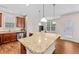 The kitchen features an island with granite countertops, stainless steel appliances, and a view of the dining area at 1839 Huntley Way, Burlington, NC 27215