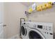 Bright laundry room with front-load washer and dryer and shelving for storage at 1839 Huntley Way, Burlington, NC 27215