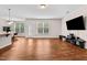 Open living area featuring hardwood floors and access to the backyard through a glass door at 1839 Huntley Way, Burlington, NC 27215
