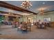 Inviting lounge area with multiple seating arrangements and chandeliers, centered around a stone fireplace at 1839 Huntley Way, Burlington, NC 27215