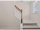 Carpeted staircase with decorative stained wood handrail and bright natural light at 1839 Huntley Way, Burlington, NC 27215