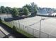 Community tennis courts surrounded by lush landscaping, with a pool and clubhouse nearby at 1839 Huntley Way, Burlington, NC 27215