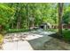 Expansive backyard featuring a basketball court, volleyball net, and a versatile storage shed at 2029 Atkins Dr, Raleigh, NC 27610