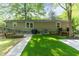 Beautiful backyard with a stone patio, grass, and a deck at 2029 Atkins Dr, Raleigh, NC 27610