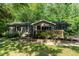 Charming single story home with a welcoming entrance surrounded by lush landscaping and mature trees at 2029 Atkins Dr, Raleigh, NC 27610