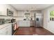 Beautiful kitchen with stainless steel appliances, granite counters, and hardwood floors at 2029 Atkins Dr, Raleigh, NC 27610