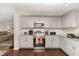 Bright kitchen featuring stainless steel appliances, granite counters, and sleek grey cabinets at 2029 Atkins Dr, Raleigh, NC 27610
