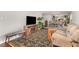 Comfortable living room featuring a plush sofa, wooden accents, and a vibrant patterned rug creating a warm atmosphere at 2029 Atkins Dr, Raleigh, NC 27610