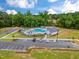 Aerial view of community pool, clubhouse, parking, and landscaping with trees and blue skies at 246 Pretty Run Branch Ln, Wendell, NC 27591