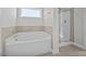 A bright bathroom features a large soaking tub and glass enclosed shower at 246 Pretty Run Branch Ln, Wendell, NC 27591