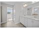 A well-lit bathroom featuring double sinks with white cabinets and a separate shower at 246 Pretty Run Branch Ln, Wendell, NC 27591