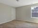 A bedroom with carpeted floors, neutral walls, a closet, and a window, perfect for relaxing at 246 Pretty Run Branch Ln, Wendell, NC 27591