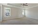 A spacious bedroom with tray ceiling, plush carpeting, and plenty of natural light at 246 Pretty Run Branch Ln, Wendell, NC 27591