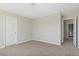 A bright bedroom with carpeted floors and a door leading to an adjacent space at 246 Pretty Run Branch Ln, Wendell, NC 27591