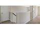 A bright upstairs hallway featuring neutral colored walls and carpet at 246 Pretty Run Branch Ln, Wendell, NC 27591