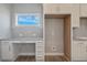 A well-lit laundry room with granite countertops and stylish backsplash plus washer/dryer hookups at 246 Pretty Run Branch Ln, Wendell, NC 27591