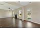 Spacious living room with hardwood floors, a fireplace, ceiling fan, and access to the back yard at 246 Pretty Run Branch Ln, Wendell, NC 27591
