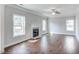 Spacious living room features a ceiling fan, fireplace, hardwood floors, and bright, natural light at 246 Pretty Run Branch Ln, Wendell, NC 27591