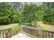 Home's backyard features a deck, grassy area and mature trees offering shade at 25 Williamston Ridge Dr, Youngsville, NC 27596