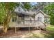 Backyard with deck, mature tree offering shade from back side of home at 25 Williamston Ridge Dr, Youngsville, NC 27596